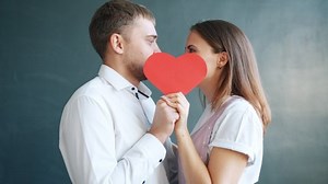 clip-1041884020-beautiful-young-couple-man-woman-kissing-hiding