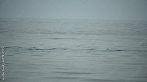 Happy couple kayaks in an inflatable kayak on the sea at sunset. Couple kanoeing in the sea near the island with mountains. People kayaking in life jackets sail. Back view