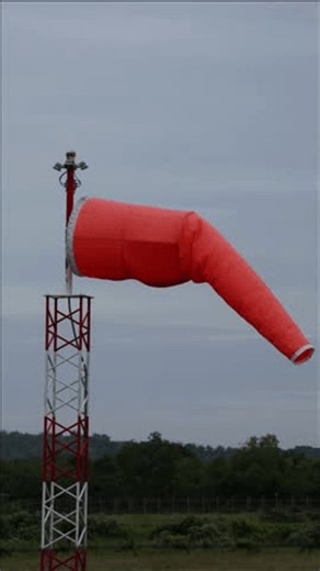 clip-3989026731-vibrant-orange-windsock-mounted-on-red-and-white-lattice