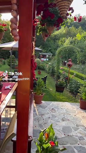 Serene Outdoor Garden with Flower Baskets and Pizza Oven