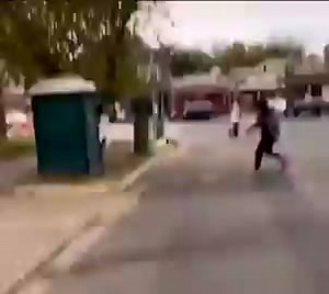 Guy tips over a porta potty with a girl inside