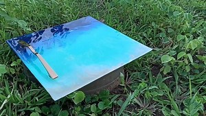 Epoxy Resin serving Tray with handcrafted chrome handle A perfect, highly customized and unique #gift #epoxy #epoxyresin #resinart #beautiful #blue #ocean #theme #tray #traydecor #trays | Essential Artworks | Facebook