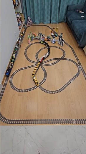 Lego trains looping on two interconnected tracks with a bridge and crossings