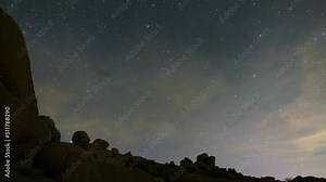 Time lapse pan of Milky Way galaxy rising followed by moonrise in Mojave Desert, California, USA