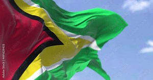 Detail of the national flag of Guyana waving in the wind on a clear day