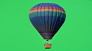 Download A vibrant hot air balloon ascends against a vivid green screen. for free