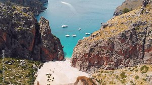 Sa Calobra, Torrent De Pareis beach with turquoise sea water and moored boats, Serra De Tramuntana, Aerial Drone dolly in tilt down establishing shot
