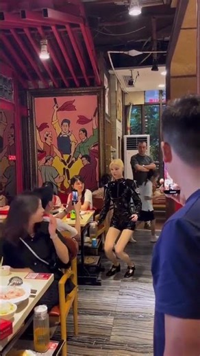 The robots with a strong sense of technology wander around in the restaurant.