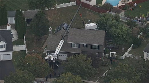 Crane collapses onto New Jersey home while moving hot tub