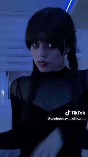 Wednesday Addams is a fictional character from the Addams Family franchise, created by cartoonist Charles Addams. She is typically portrayed as a young girl with a pale complexion, long dark braids, and a gothic style of dress, often wearing a black dress with a white collar. Wednesday is known for her macabre interests, deadpan humor, and stoic demeanor. She exhibits a fascination with the morbid and bizarre, often displaying a dark sense of humor and an affinity for the occult. Despite her eer