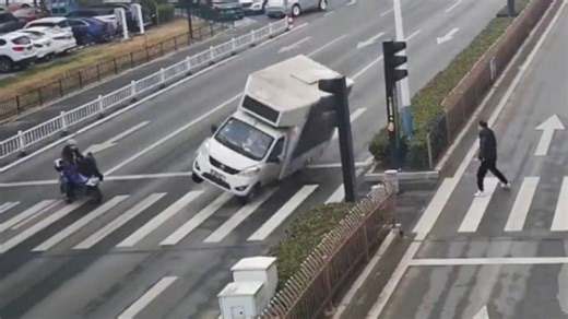 Distracted truck driver overturns swerving to avoid motorbike