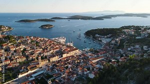 Old town Hvar with port in Adriatic sea and Paklinski islands, Dalmatia, Croatia. Aerial drone 4k video. Summer vacation destination