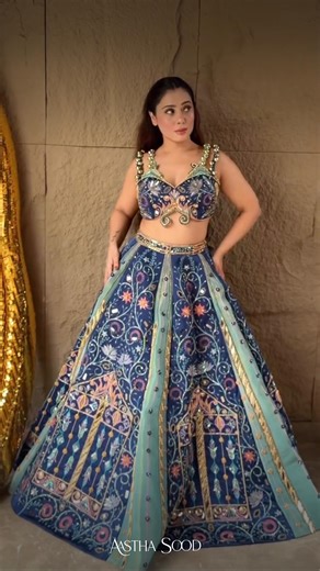 Aastha Sood on Instagram: "Step into a world of whimsy and wonder with the ”Enchanted Lehenga” from our latest collection, where fairy tales come alive! Crafted in a spellbinding blend of navy blue and aqua tissue fabric with dual-coloured kalis, this lehenga is adorned with opulent Zardozi embroidery that shimmers like stardust. The blouse is enhanced with delicate handmade chains, while subtle covered accents weave in a touch of mystical charm. Paired with our signature duppata, this look is p