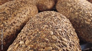 Homemade bread with seeds on bakery display shelf window