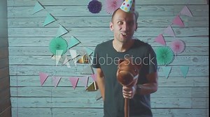 young attractive man on rocking horse with a cap on his head. Happy birthday concept