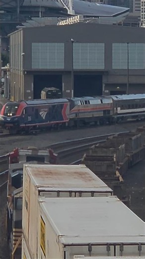 unknown northbound stack train passes newly delivered amtrak cascades airo.