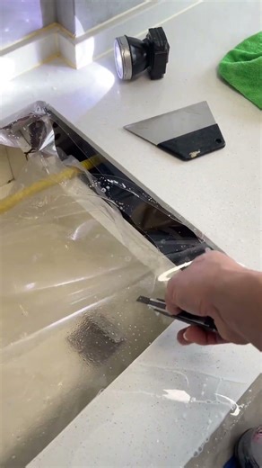 Kitchen countertop film application for quartz stone surfaces; decorative film application.