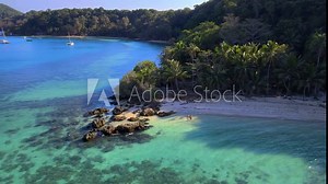Koh Wai Island Trat Thailand is a tinny tropical Island near Koh Chang. wooden bamboo hut bungalow on the beach. a young couple of men and women walking on a natural tropical Island in Thailand