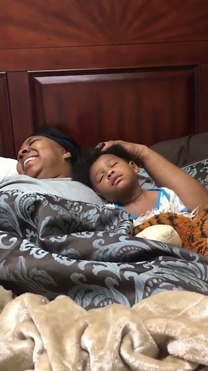 Grandma Helps Drowsy Grandson Fall Asleep