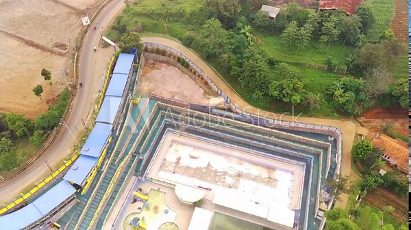 Drone Footage. Aerial view of a long abandoned swimming pool in West Java Province, Indonesia. The swimming pool is deserted, uninhabited and dirty. Shot in 4K Resolution Video 30fps