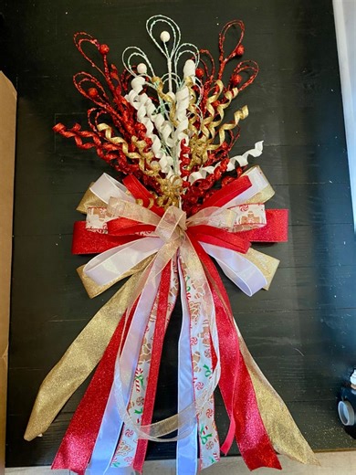 2.1K views · 18 reactions | I have this elegant tree topper available for $60 plus shipping, featuring a traditional white, gold and red design.with a touch of gingerbread print ribbon. #Treetopper #christmas2025 #christmasdecorations #christmasdecor #christmastreetopper #christmastreedecor | E.QUTE Crafts Shop. | Facebook
