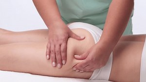 The masseur makes a massage on the abdomen, waist and hips in the spa. Overweight treatment, body sculpture. The concept of cosmetology and massage.