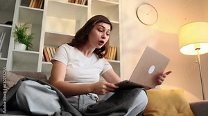 Arguing young woman student or freelancer yelling at laptop by conference video call at home Angry nervous female talk by computer expressing negative emotion indoors Bad conflict conversation