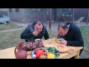 COOKING FISH in a CAULDRON in an OPEN FIRE.