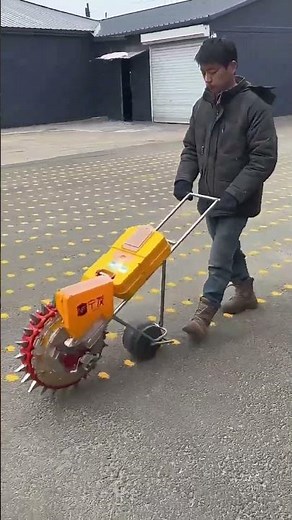 This Crazy Guy Planting Corn On Concrete With A Hand-Pushed Seeder !
