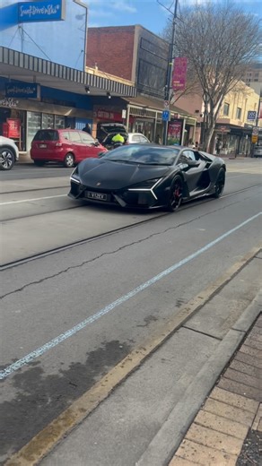 Adelaide Car Community on Instagram: "A menacing Lamborghini Revuelto was spotted today at Glenelg, Jetty Rd! With plates ‘V12EV’ highlighting the hybridised naturally aspirated V12 engine. This specific one believed to also be straight piped absolutely screams at higher RPM’s like a legitimate F1 car. Combining electric motors and the engine for an output of 1000 horsepower. What do we think of this incredible spot in Adelaide? 📸 @lucas_full67 #adelaide #carspotting #lamborghini #revuelto"