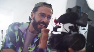 Slow Motion Portrait of Male Cinematographer Working On a Filming Set, Using Digital Camera to Shoot High-Quality Footage for Cinematic Project. Creative Man Operating a Camera and Giving Instructions