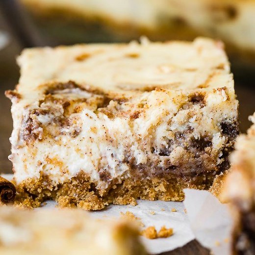 Cheesecake bars hooked up with cinnamon rolls and became the best dessert you’ll have all year — Blender Cinnamon Roll Cheesecake Bars!! The sweet and salty cinnamon graham cracker crust pops under the luscious and rich cinnamon swirled cheesecake. RECIPE: https://ohsweetbasil.com/blender-cinnamon-roll-cheesecake-bars/ | Sweet Basil
