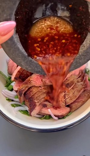 Nam tok, this Southeast Asian famous delight, is a unique way to create unforgettable dinner moments for your family! Credit: @ronis_recipes Super Easy Nam Tok for Dinner INGREDIENTS 2 sirloin steaks 1 red onion, thinly sliced 1 cup coriander leaves 1 cup mint leaves 1 scallion, chopped 5 tablespoons olive oil Coarse salt Sauce: 2 tablespoons rice vinegar 6 tablespoons lemon juice 6 tablespoons fish sauce 1 tablespoon sugar 1 tablespoon dry chili flakes STEP 1 Heat olive oil in a pan on high hea