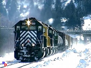 Two Montana Rail Link trains are seen on a sunny, but obviously cold winter day on Bozeman Pass. From the Highball Productions show "Winter on the Montana Rail Link" https://rfd.video/WinterMRL | Railfan Depot