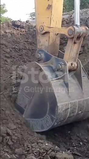 The bucket pours out mud and mud