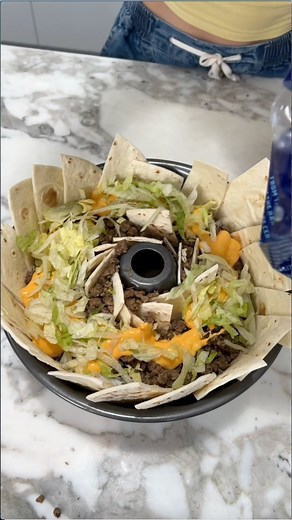 Easy 1 pan dinner everyone will love Allie uses a bundt pan to create a delicious taco dish by using tortilla strips as base layer and adding taco ingredients. This original video was produced by Justine and Allie can cook, Network Media and Allie Sparks. | Whisk Takers