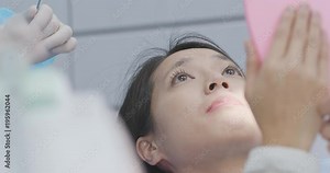 Woman checking on her teeth in dental office