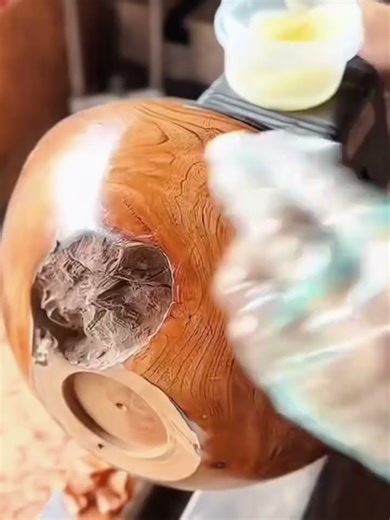 polishing a wooden bowl to make it shiny and glossy