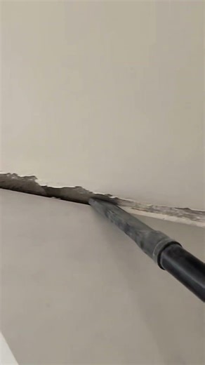 cleaning cement residue from gaps between walls and floors using a vacuum to be very neat and clean