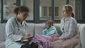 Female doctor visiting a sick girl - Free Stock Video