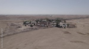 Parallax photography of houses without a permit in a remote and desert area, near a highway, with dry land without crops(D-LOG)