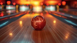 Download This Red bowling ball placed on top of the lane at a bowling alley. for free