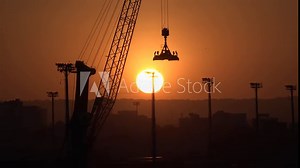 Container cargo terminal. Huge industrial dock area for world trade commerce. Export and import business and logistics. Container cargo freight ship with working crane bridge at international port.