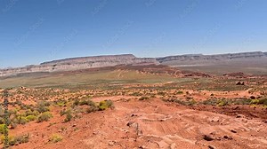 Riding UTV 4x4 off road dry red rock desert Utah POV. Southern Utah desert Sand Hollow. Red sandstone, dirt, sand trails. Outdoor extreme 4x4 recreation ride and adventure. Recreation.