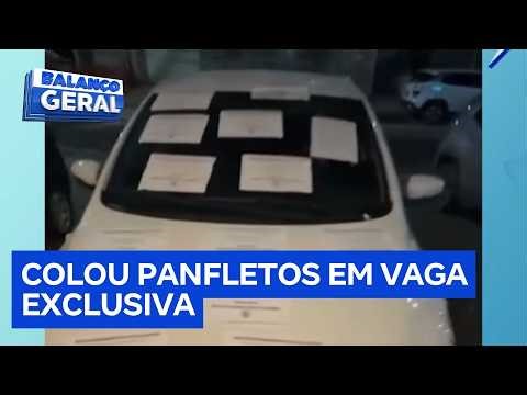 A merchant pastes dozens of flyers onto a car parked in a customer area.