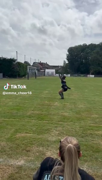 Exciting Cheerleading Tumbles on Grass