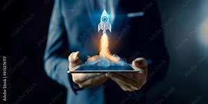 Businessman holding tablet with rocket icon on the screen showing startup concept, technology in business, innovation and growth