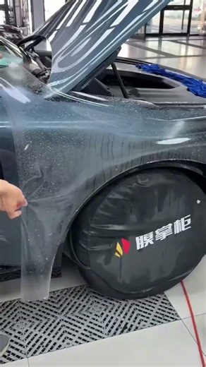 They install a scratch resistant plastic layer on the car body using water to smooth the surface