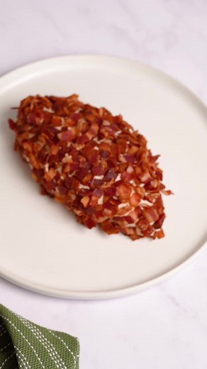 Score big with this football-shaped cheese ball made with Roth Cheese. 🧀🏈 | Roth Cheese