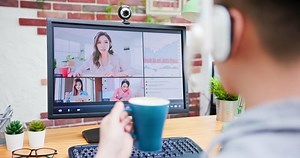 telework concept - Asian man use computer and headphone microphone to join a video meeting at home